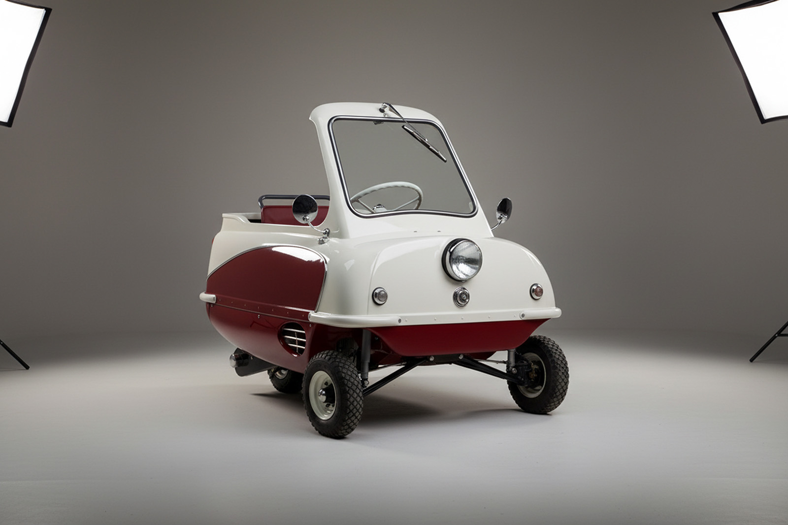 replace the background of this image of a rear angled view of a peel p50 convertible with a high end automotive photostudio backdrop like in premium automotive photography.